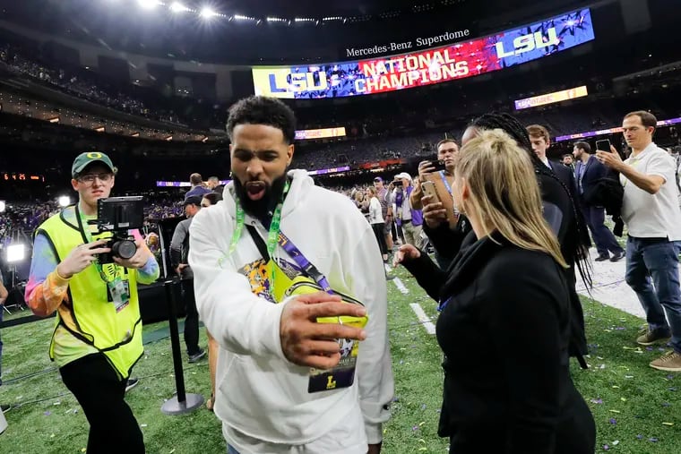Cleveland Browns wide receiver and former LSU star Odell Beckham Jr. walks off the field after the NCAA College Football Playoff national championship game between Clemson and LSU in New Orleans. The NFL star was banned from LSU for two years after handing out $2,000 in cash to players.