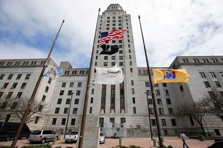 Flags fly at half-staff in front of the Camden City Hall on Friday, April 3, 2020.  New Jersey Governor Murphy directed the U.S. and New Jersey flags to fly at half-staff indefinitely in honor of those who have lost their lives or have been affected by the COVID-19 virus.