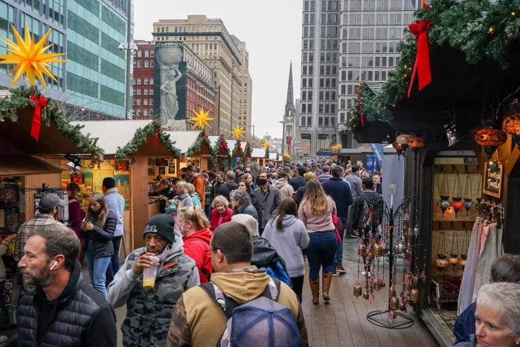 People browse and shop at Christmas Village at LOVE Park in Philadelphia on Saturday.