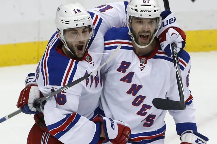 New York Rangers' Derick Brassard (16) celebrates his goal with Benoit Pouliot (67) in the first period of Game 5 of a second-round NHL playoff hockey series against the Pittsburgh Penguins in Pittsburgh, Friday, May 9, 2014. (AP Photo/Gene J. Puskar)