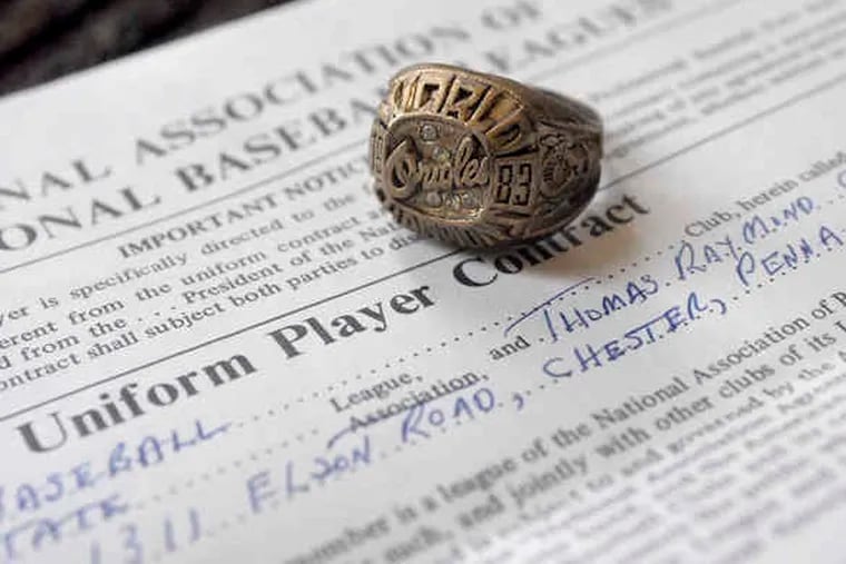 A replica of Tom Chism's World Series ring rests atop the first baseball contract he signed, in 1974. The real ring, which he received for his years spent with the Orioles, was stolen last fall.