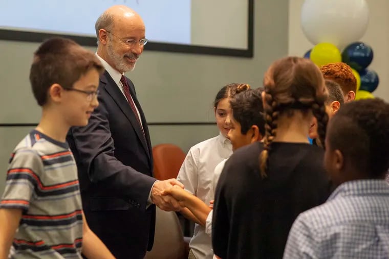 Gov. Wolf, shown in this file photo with Philadelphia schoolchildren, is de-emphasizing standardized tests.