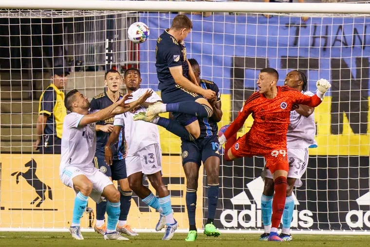 Mikael Uhre (center) leaps to score the tying goal for the Union.