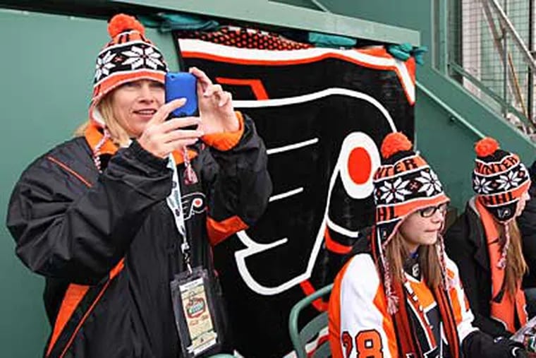 Flyers fans looked on while the Flyers played the Bruins in the Winter Classic at Fenway Park. (Michael Bryant / Staff Photographer)