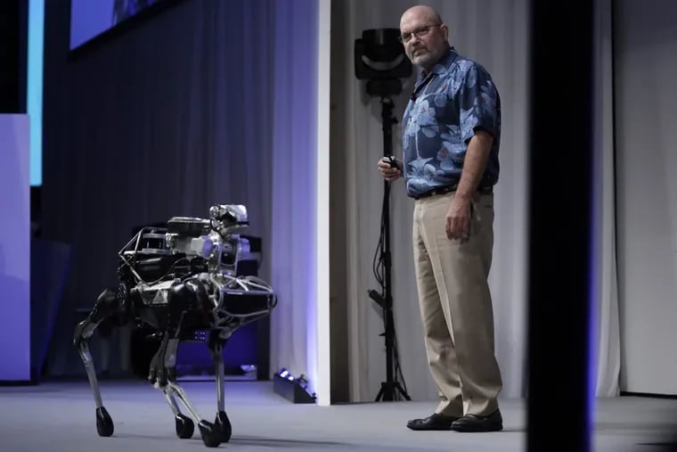 Boston Dynamics CEO Marc Raibert demostrates the company's SpotMini robot at SoftBank World 2017 in Tokyo on July 20, 2017.
