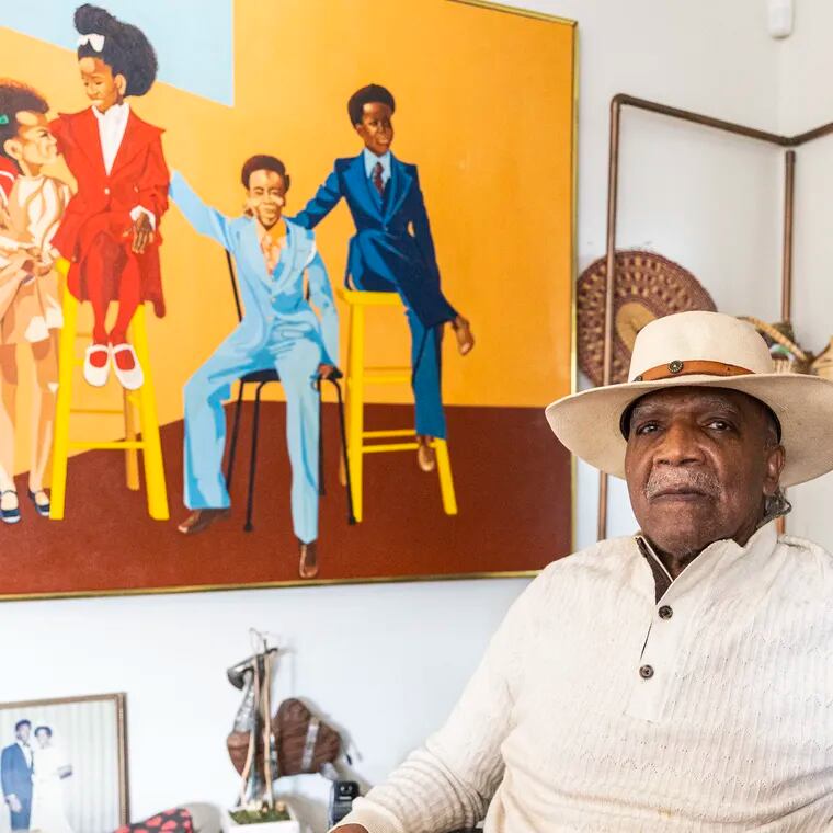 Curtis Brown, of North Philadelphia, 82, poses for a portrait in front of one of his pieces called “Cousins” at his home. “I want people to see my work to be inspired,” Brown said. “I want them to reflect on the positivity on African Americans.”