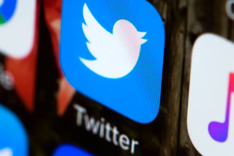 FILE - This April 26, 2017, file photo shows the Twitter app on a mobile phone in Philadelphia.  Twitter will now prohibit hate speech that targets religious groups using dehumanizing language. The social network already bans hateful language related to religion when it's aimed at individuals.