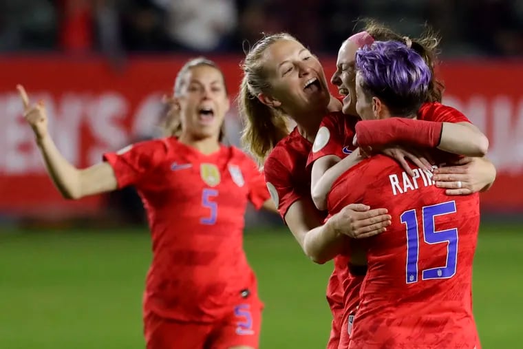 Kelley O'Hara, Sam Mewis, Rose Lavelle and Megan Rapinoe (from left to right) celebrate Lavelle's goal during the first half.