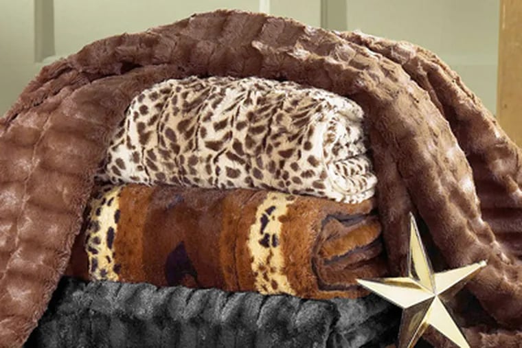 Faux fur throws , available at Sears, can give a quick makeover during the holidays to sofas, chairs - even beds. (AP)