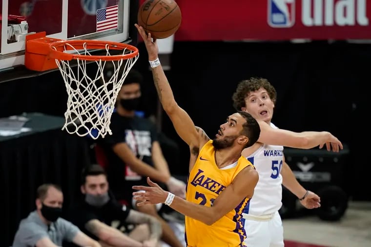 Los Angeles Lakers' Trevelin Queen shoots around Golden State Warriors' Kyle Guy during the second half of an NBA Summer League basketball game on Aug. 17, 2021, in Las Vegas.