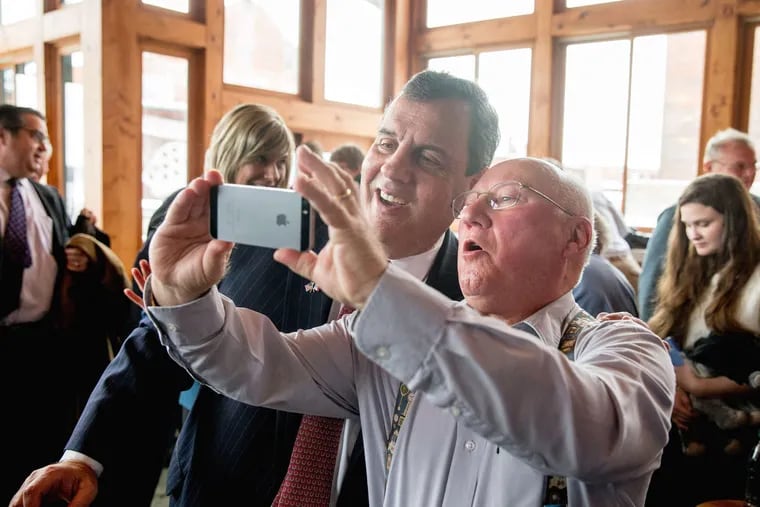 In Muscatine , Iowa, Gov. Christie posed Tuesday for a selfie with a supporter at Elly's Tea & Coffee House. ANDREW HARNIK / Associated Press