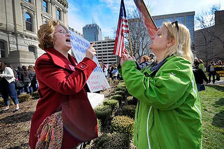 Planned Parenthood supporter Peg Paulson of Carmel, Ind., left, and opponent Heather Pruett of Indianapolis argue during a rally in 2011. (AP Photo / The Indianapolis Star, Alan Petersime)