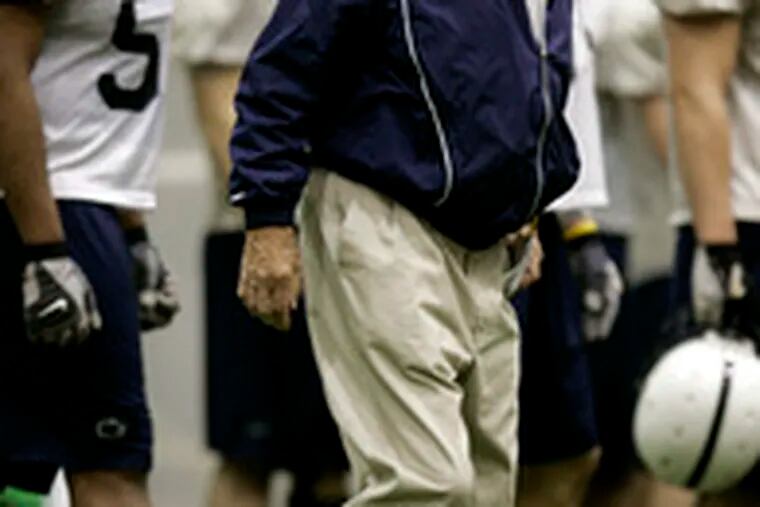 Penn State coach Joe Paterno walks the sideline during spring practice. &quot;I&#0039;m not doing as much as I like to do,&quot; Paterno said.