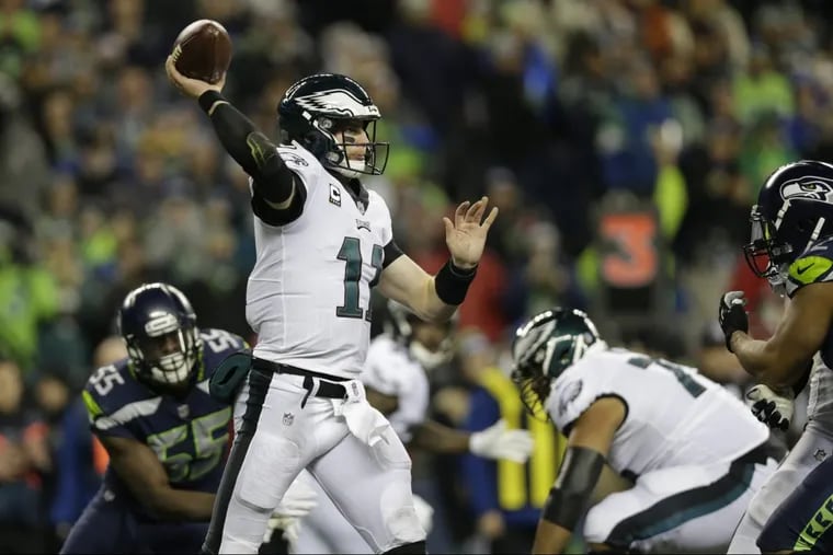Philadelphia Eagles quarterback Carson Wentz in action against the Seattle Seahawks in the first half of an NFL football game, Sunday, Dec. 3, 2017, in Seattle. (AP Photo/John Froschauer)