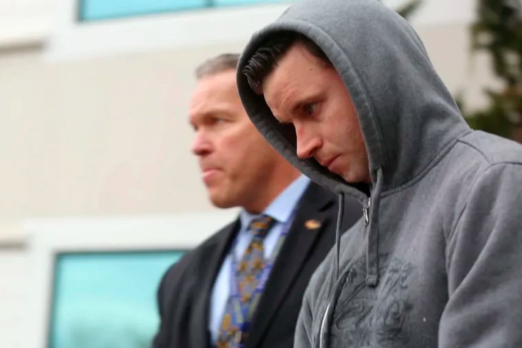 John Sher, right, a firefighter with the Margate, N.J., City Fire Department is escorted from the FBI office in Linwood, N.J., Friday, March 15, 2019. Authorities say a police officer and three firefighters are among seven people recently charged in a $50 million prescription drug scheme that has already produced nearly two dozen guilty pleas.