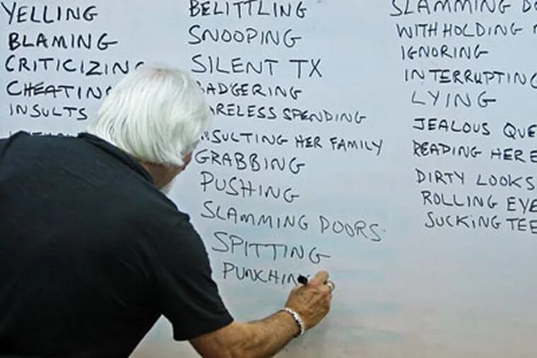 During a group session recently, Paul Bukovec, director of Menergy, wrote down words is clients called as defintions of emotional abuse. (Michael Bryant / Staff Photographer)