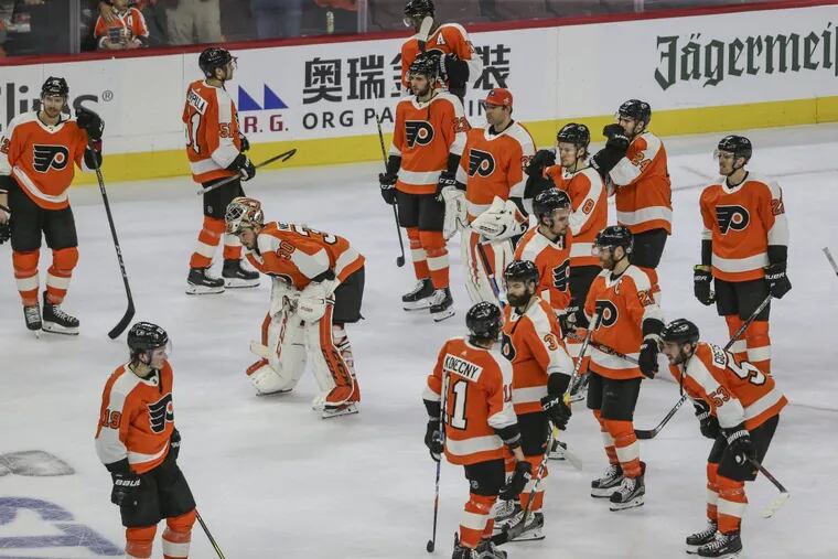 Dejected Flyers players after losing their first-round series to the Penguins on Sunday.