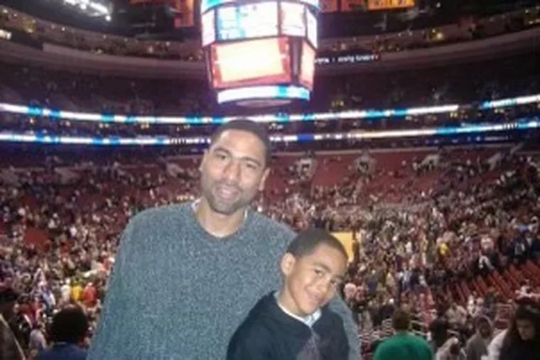 Craig Young with his son, Bryce, at a Sixers game