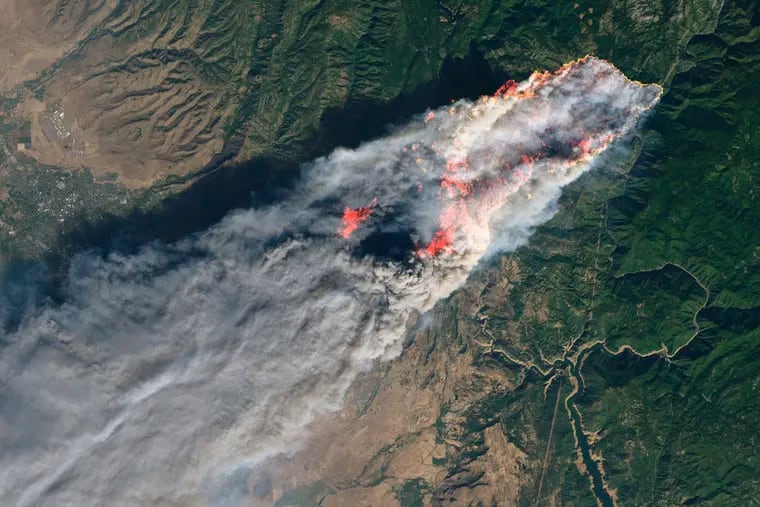 This November 2018 image provided by NASA shows flames and smoke from the Camp Fire that erupted 90 miles north of Sacramento, Calif. Increasingly intense wildfires that have scorched forests from California to Australia are stoking worry about long-term health impacts from smoke exposure in affected cities and towns.