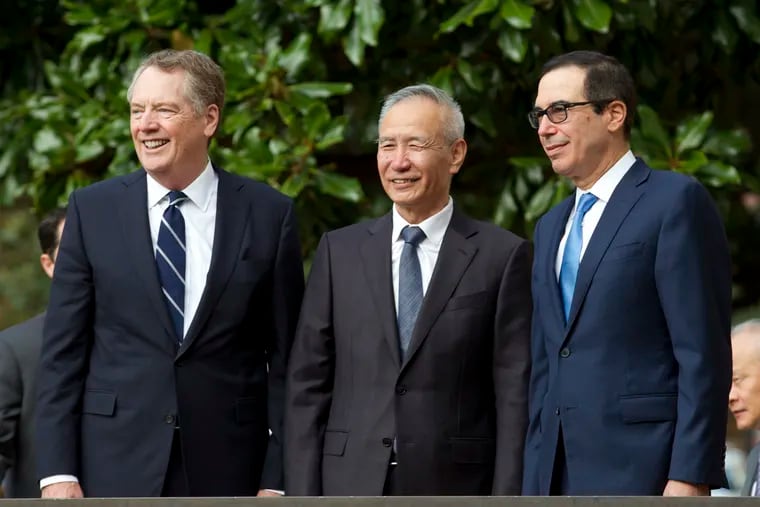 Chinese Vice Premier Liu He accompanied by U.S. Trade Representative Robert Lighthizer, left, and Treasury Secretary Steven Mnuchin, greets the media before a minister-level trade meetings at the Office of the United States Trade Representative in Washington, Thursday, Oct. 10, 2019.