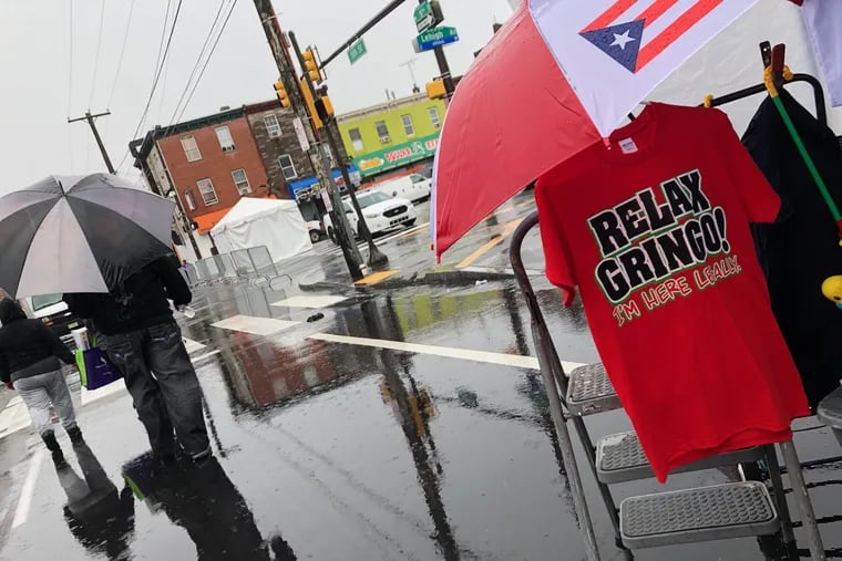 Merchants sell t-shirts with Puerto Rican slangs at a rainy Feria del Barrio in Fairhill, Philadelphia. September 23, 2018.