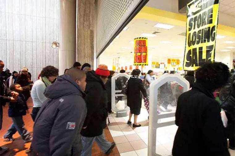 As the gates went up at the Gallery Kmart on Feb. 9, customers were ready for bargains. The store is closing 17 years after a heralded opening. (Ed Hille / Staff Photographer)