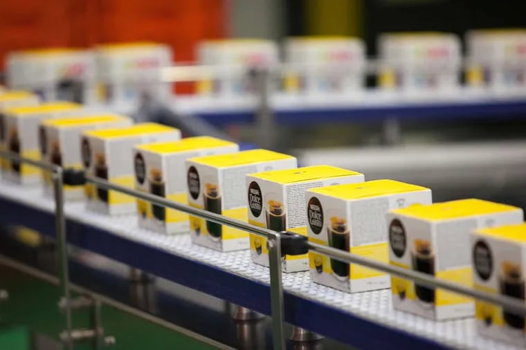 Boxes of Nescafe Dolce Gusto coffee capsules on the production line at the Nestle factory in Schwerin, Germany. The factory, one of Nestle's biggest investments in Europe, will produce about two billion capsules a year for Germany and other European markets.
