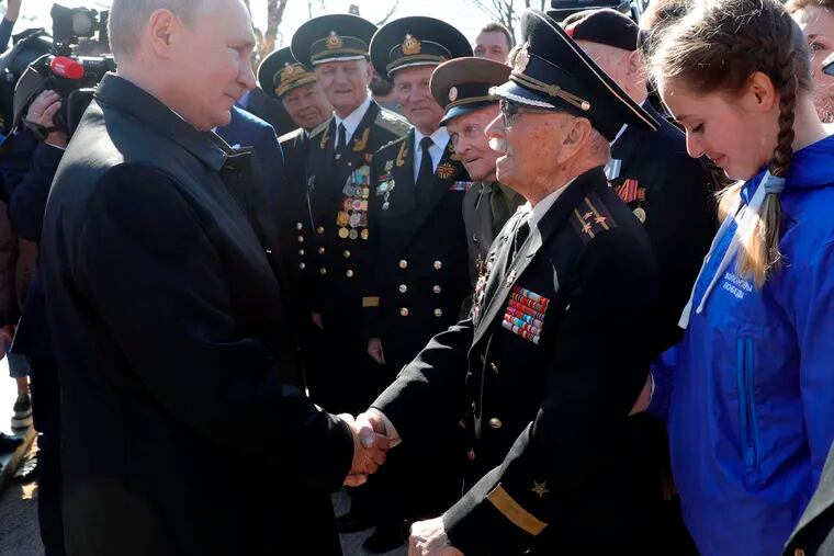 Russian President Vladimir Putin, right, meets with local residents and veterans at the historical memorial the Malakhov Kurgan (Malakoff redoubt) in Sevastopol, Crimea, Monday, March 18, 2019. Putin visited Crimea to mark the fifth anniversary of Russia's annexation of Crimea from Ukraine by visiting the Black Sea peninsula. (Mikhail Klimentyev, Sputnik, Kremlin Pool Photo via AP)