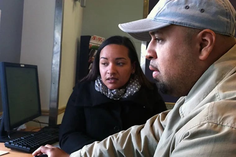 Moises Candray, 30, creates an account at Healthcare.gov with help from Samantha Rivera during a health fair Friday, Oct. 25, at Congreso, the Latino human services organization in North Philadelphia. Candray is hoping to buy insurance through the exchange for himself; his wife and kids are covered through her employers's policy, which he said would cost $500 more a month with him on it. Although he created an account at Congreso, the web site would not let him go any further to determine what subsidy he might qualify for or to see his plan choices. Candray, a restaurant manager whose employer does not offer insurance, has gone back online from home several times since - at night and during the day, on a computer and a smartphone - but has not gotten any further. ( Don Sapatkin / staff )