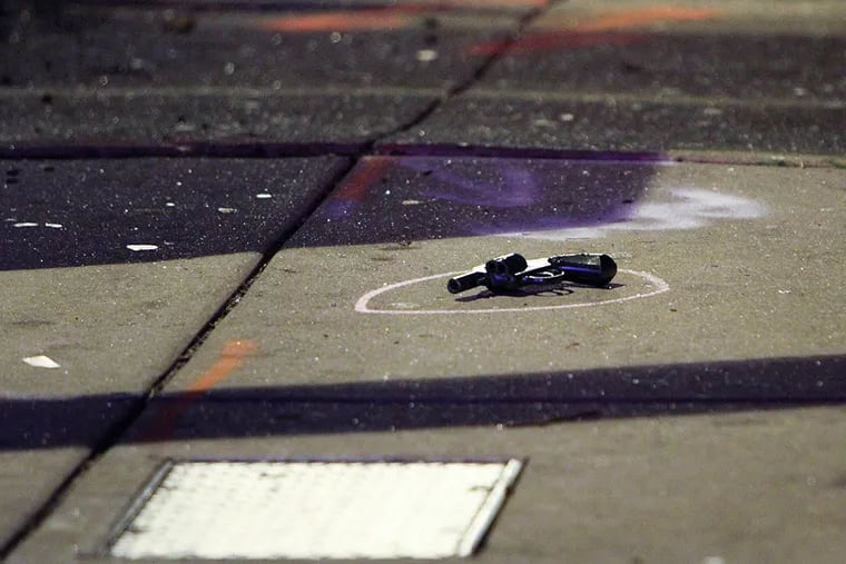 A revolver laying on the sidewalk on Torresdale Avenue near Magee Avenue in the Tacony section of Philadelphia early Tuesday after a Philadelphia police officer was wounded during an exchange of gunfire with a suspect.