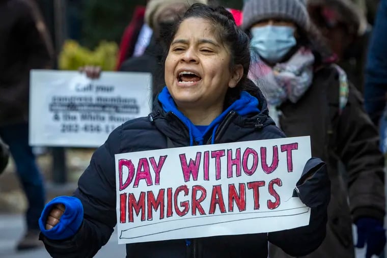 Activist Ivonne Pinto marches at group makes its way around Philadelphia City Hall. The rally, A Day Without Immigrants, started at Love Park and worked its way around City Hall to Municipal Services Building where group gave speeches on Monday.