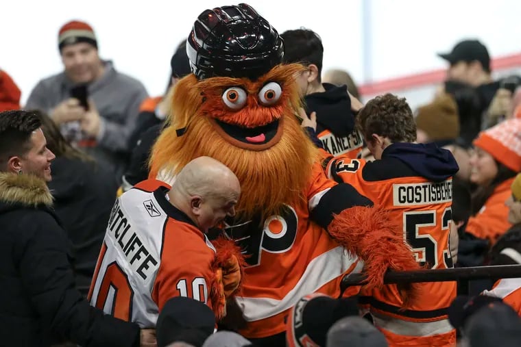 Flyers mascot Gritty hanging out with fans during a game in January.