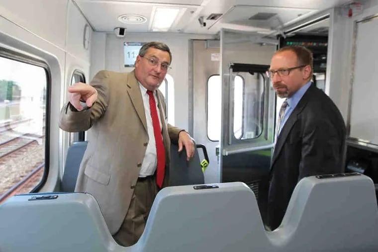 SEPTA GM Joe Casey makes a point with Peter Rogoff, of the Federal Transportation Administration, during a regional rail ride to Jenkintown.