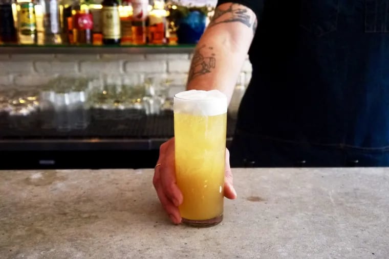 The Summer Gold cocktail at V Street is made with orange wine, ginger and fermented pineapple tepache .