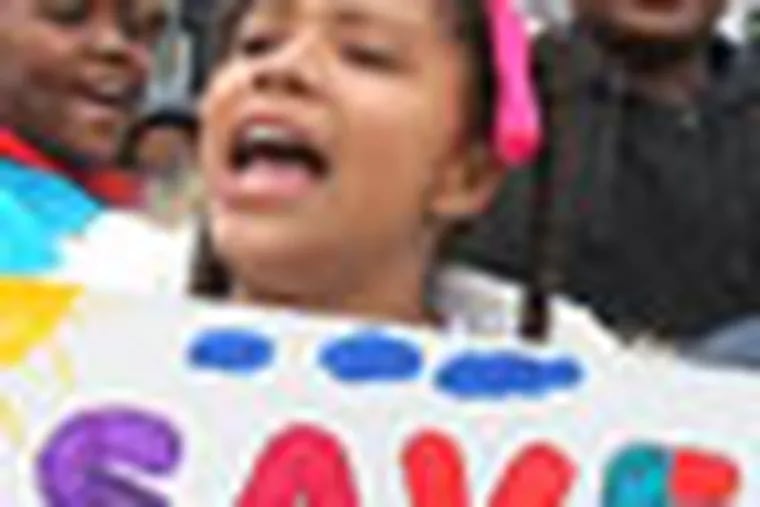 Students from the Creighton School, including Aaniyah Sullivan, center, rally prior to a public hearing by the School Reform Commission and their voting on the recommended closings of 9 district schools and grade changes at 17 others.  The protest was held outside the Philadelphia School District Building on March 29, 2012. ( Charles Fox / Staff Photographer )