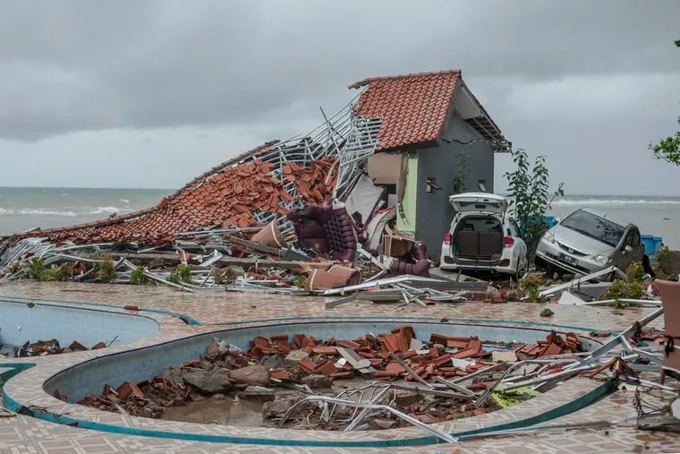 Debris littered a property badly damaged by a tsunami in Carita, Indonesia, Sunday, Dec. 23, 2018. The tsunami occurred after the eruption of a volcano around Indonesia's Sunda Strait during a busy holiday weekend, sending water crashing ashore and sweeping away hotels, hundreds of houses and people attending a beach concert. (AP Photo/Fauzy Chaniago)