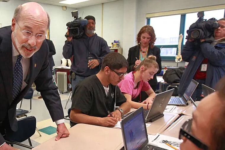 Gov. Wolf, seen here with students at Kensington Health Sciences Academy, runs city schools through the SRC. MICHAEL BRYANT / Staff