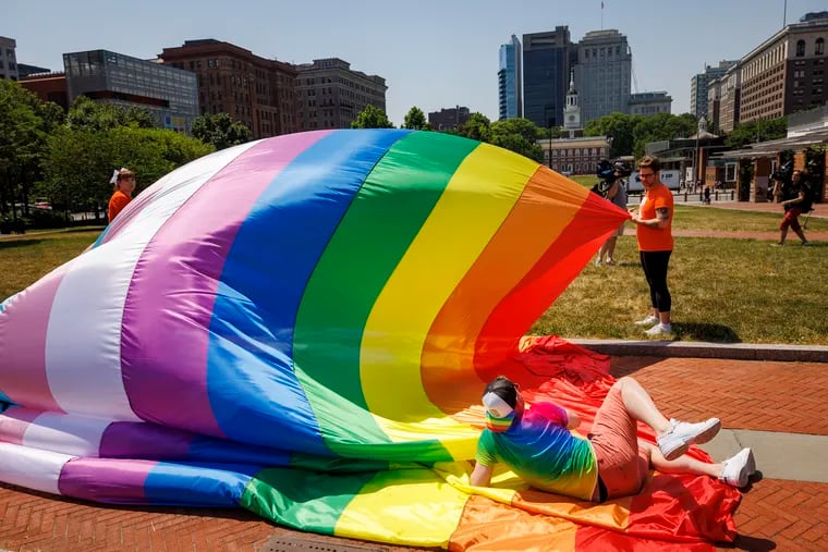 Laying on Philadelphia and Pennsylvania's largest LGBTQ+ Pride flag to hold it down is Tim McKinney, the LGBTQ+ Resource and Program Director for Big Brothers Big Sisters Independence. Planned by GALAEI, the flag is 200-ft-long and was unveiled on Independence Mall on June 2, 2023.