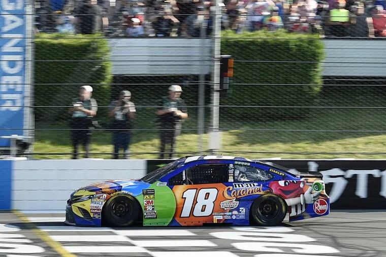 Kyle Busch crosses the finish line to win a NASCAR Cup Series auto race, Sunday, July 29, 2018, in Long Pond, Pa. (AP Photo/Derik Hamilton)