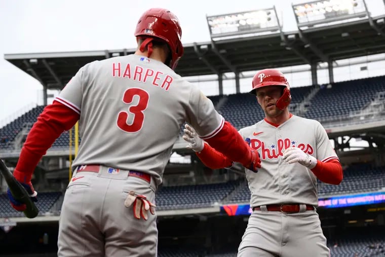 Rhys Hoskins, right, celebrates his first-inning home run with Bryce Harper on Friday.
