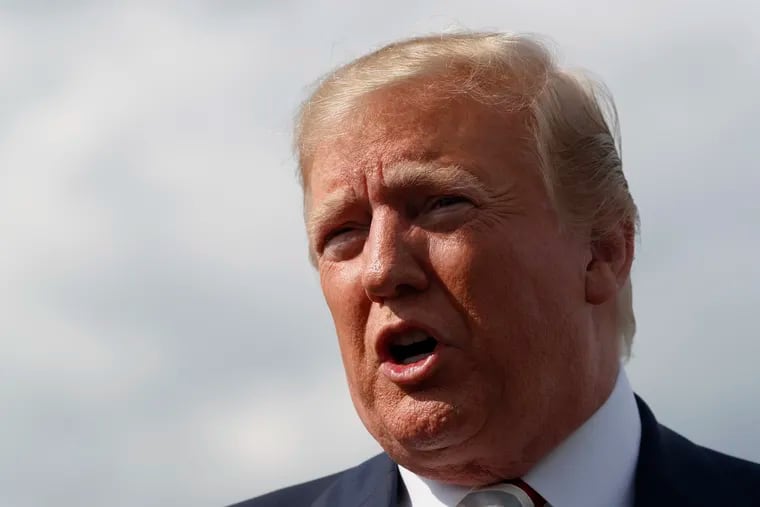 President Donald Trump speaks to reporters about the shootings in El Paso and Dayton as he boards Air Force One in Morristown, N.J., on Sunday.