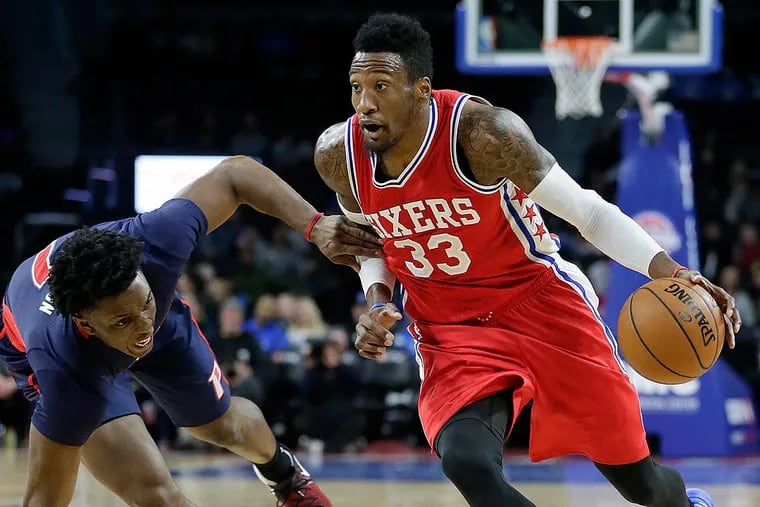 Philadelphia 76ers' Robert Covington (33) drives to the basket against Detroit Pistons' Stanley Johnson during the second half of an NBA basketball game Sunday, Dec. 11, 2016, in Auburn Hills, Mich. Covington led the 76ers with 16 points in a 97-79 win.