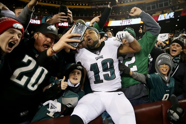 Eagles wide receiver Golden Tate (19) celebrates with fans in the stands after a game against the Washington Redskins at FedEx Field in Landover, Md. in December. For this Sunday's playoff game, fans will head to New Orleans, or catch the action at home.