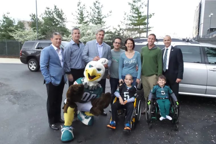 Dominic Liples (next to Swoop), and his younger brother Ciarlo, are front and center at the NovaCare Complex where they spent the day visiting with the Eagles. Also present are (second row from left), defensive coordinator Jim Schwartz, offensive coordinator Frank Reich, head coach Doug Pederson , parents  Ken and  Kira Liples, special teams coach Dave Fipp, club president Don Smolenski.