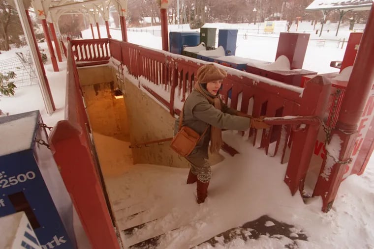 Turner Welch climbs the snow covered stairs at the Wynnewood train station underpass on Jan. 8, 1996. A blizzard that year dropped nearly 31 inches of snow on Philly, which remains a record.