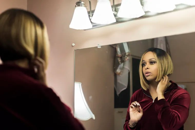 Chrisette Michele gets ready in the backroom before her concert at the Keswick Theater in Glenside, Pennsylvania, a few days after Christmas. Since singing at one of Donald Trump's inaugural balls, Michele is singing to nearly empty audiences. She says she's finding a new path to happiness.