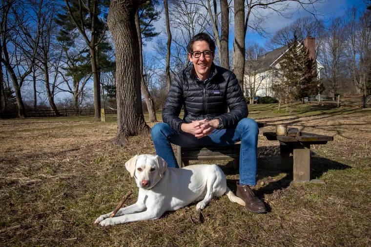 PSERS board member Joe Torsella raised questions at a pivotal meeting in December 2020 about how the pension fund computed its investment returns. Torsella, a former state treasurer, is shown here with his dog Lilly at his home.