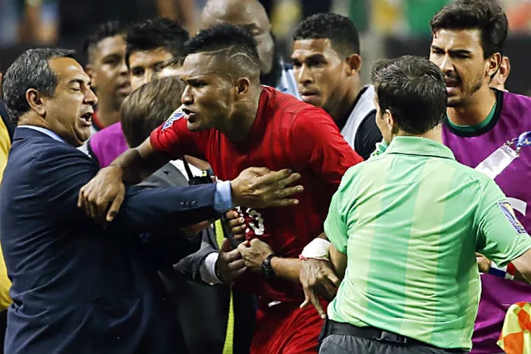 Panama's Erick Davis (center) is restrained as tempers flare during the second half of Wednesday's loss.
