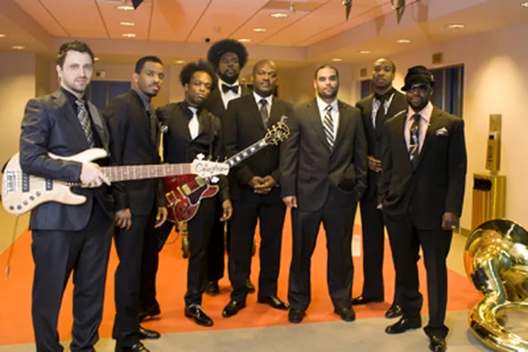 The Roots, the Philly hip-hop group that is now the house
band on Jimmy Fallon's talk show, gather outside their dressing just before going on stage. (Ed Hille / Staff Photographer)