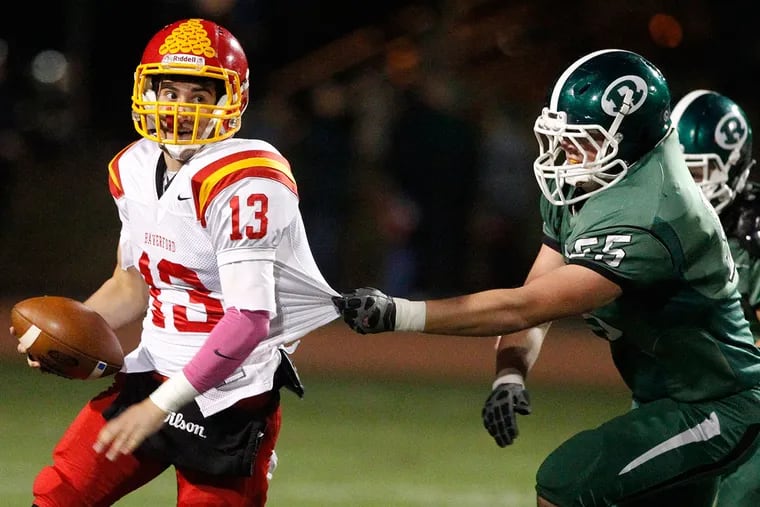 Jack Donaghy, left, of Haverford High scrambles before being brought down for a loss by Seamus Boyle of Ridley in the 2nd quarter on Oct. 30, 2015, in a key Central League football game.